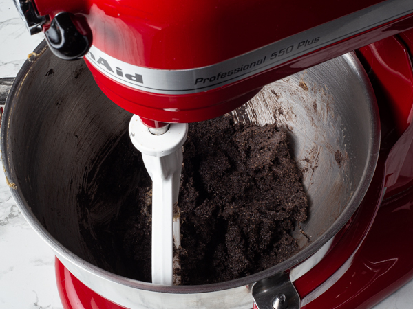 Mixed edible dark chocolate cookie dough in a stand mixer bowl