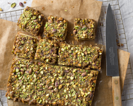 Pistachio Caramel Shortbread Bars on brown butcher paper