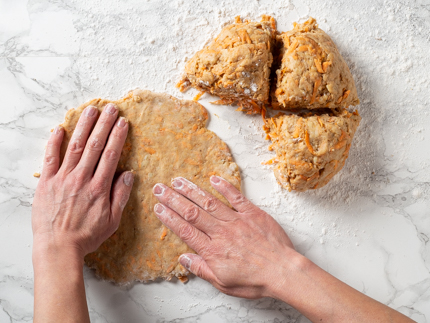 Flattening balls of dough by hand