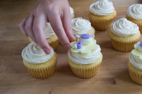 17. Place the tea cup onto the fondant cutout beside the teapot and place the entire cutout on top of the frosted cupcake. 