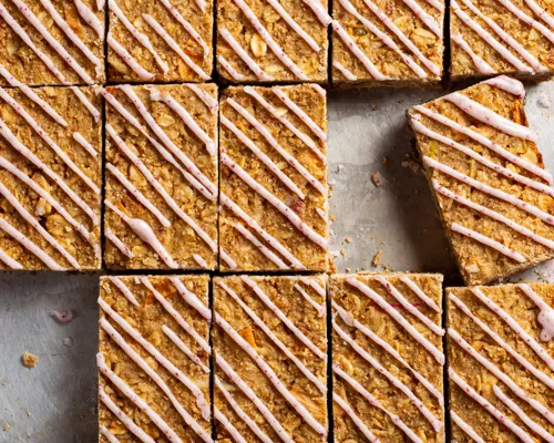 Rows of Oatmeal Apple Bars with Lemon Sumac Drizzle with two missing pieces