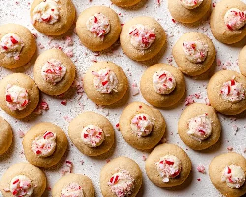 Peppermint thumbprint cookies decorated with crushed candy canes