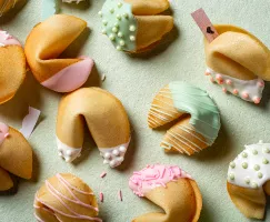 Fortune cookies dipped in icing and decorated with sprinkles